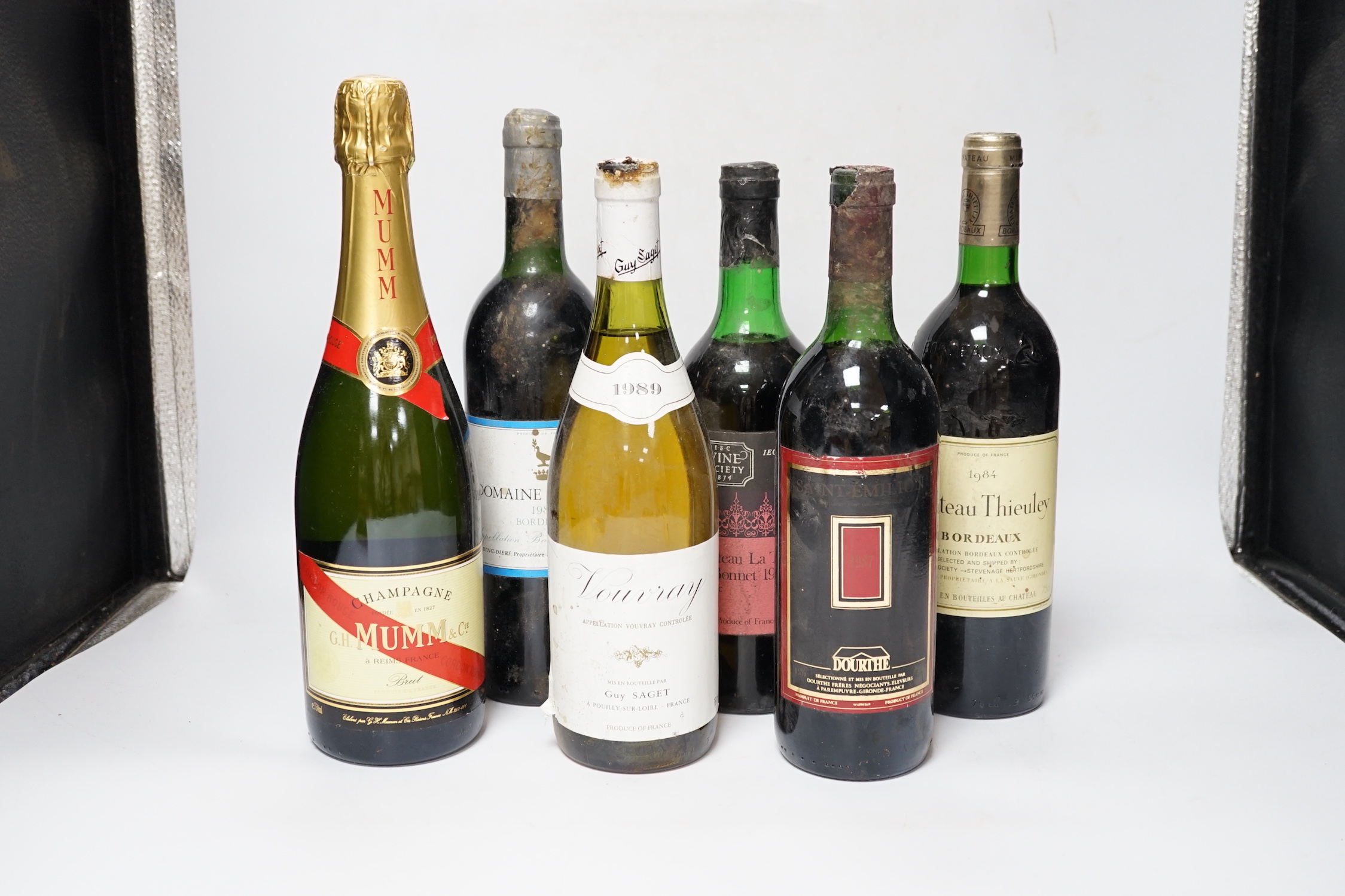 Five various bottles of wine to include Chateau La Tour St. Bonnet 1972, Vouvray 1989, Domaine La Grave 1984, Saint Emilion, Chateau Thieuley 1984 and a bottle of Mumm Champagne